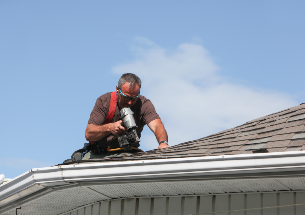 worker doing a roof maintenance using a nail gun